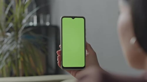 Woman Looking at Smartphone with Green Screen