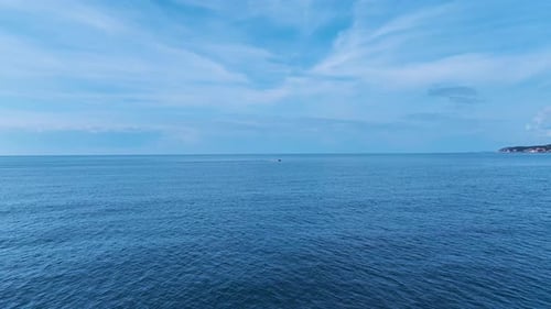 Aerial Video of a Speedboat Gliding Across the Ocean Making a White Trail As It Approaches the