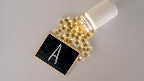 Vitamin A Capsules with Bottle and Chalkboard