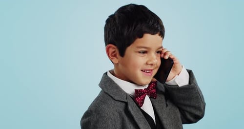 Child, talking and boy with phone call in studio, blue background and mockup with telephone chat