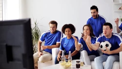 Excited Friends Watch Sports Game on TV