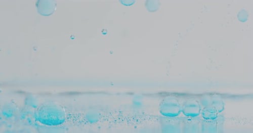 Slow motion macro of blue micro particles molecules in a liquid are analyzed with microscope for r