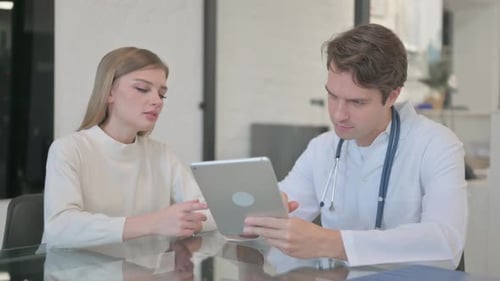 Doctor Explains Results to Patient Using Tablet