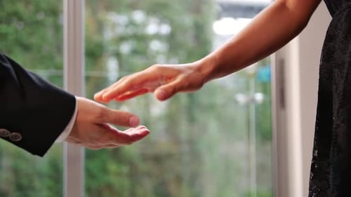 Business man kindly taking woman's hand