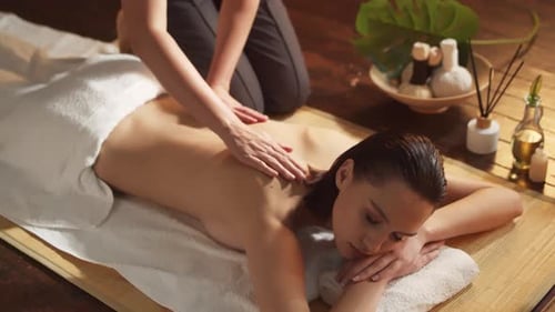 A Young Healthy and Beautiful Woman Receives Massage Therapy in a Spa Salon Concept of Health and