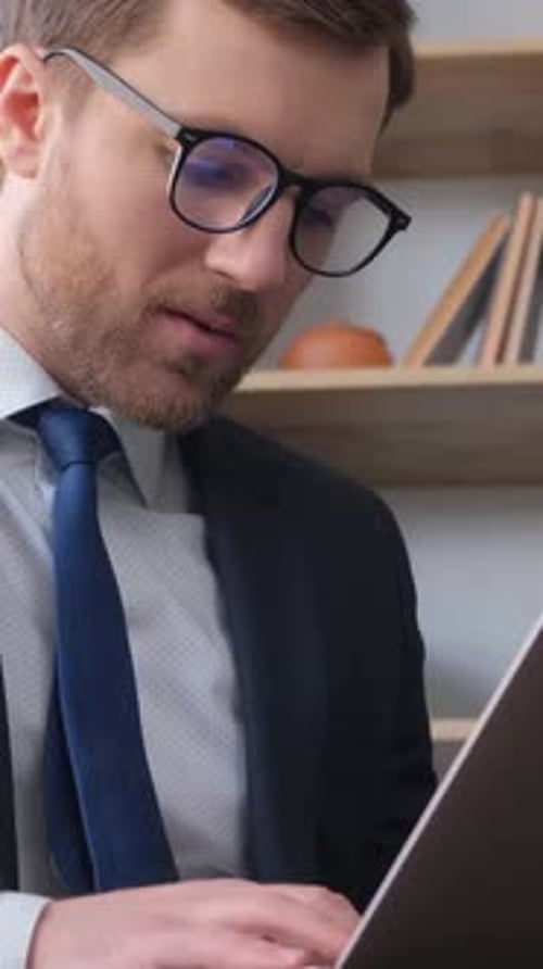 Busy Businessman in Office Working on His Laptop Vertical Video