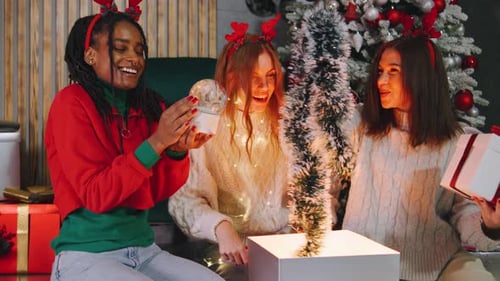 Friends Open Christmas Presents Together at Home