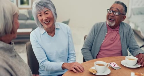 Seniors Playing Cards and Drinking Tea