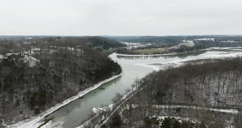 Serene frosty scenery of wintertime woodland, quiet lake and vast horizon.