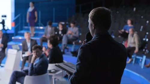 Speaker Presents to Audience at Corporate Conference