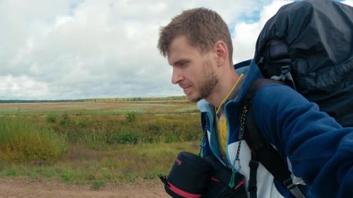 Man Hiking with Backpack in Rural Landscape