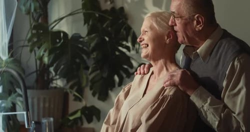 Loving Senior Couple Embracing Indoors