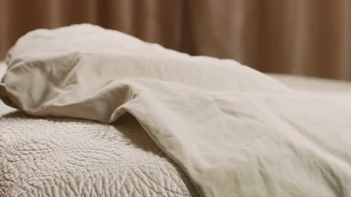 Clothes Piling Up On Top of a Bed