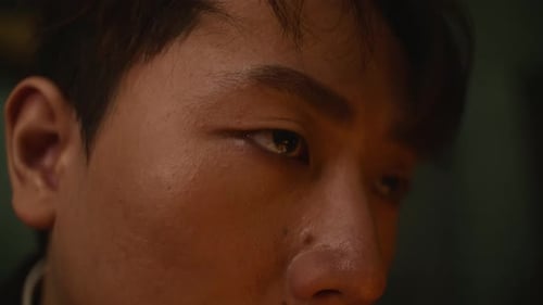 Close-up shot of a man’s intense gaze expressing deep thought or inner conflict