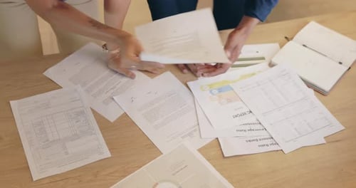 Closeup, top view and business people with paperwork, team planning and documents at table