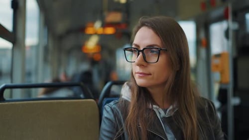 Public Transport Woman in Glasses Riding a Tram in the City Slow Motion