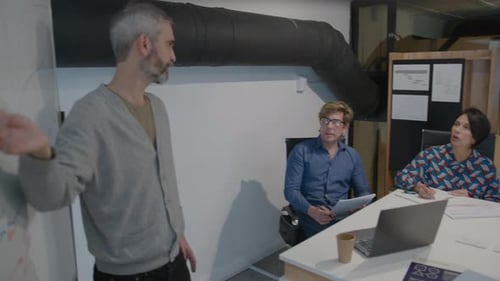 Professionals Collaborate During a Meeting in Modern Office