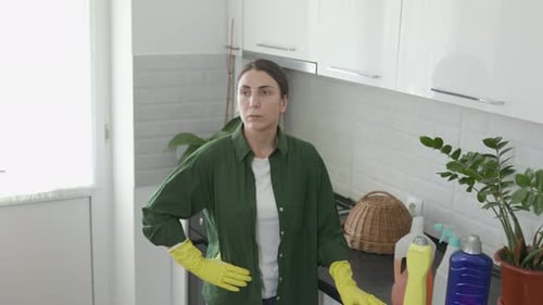 Woman in Kitchen Wearing Cleaning Gloves