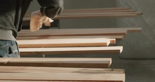 Sawdust Sweep A Carpenter Dusting Off Wood Boards After Sanding In The Finishing Process