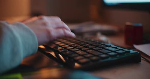 Woman Hands Typing On Computer Keyboard Late At Night