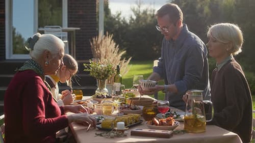 Family enjoying a sunny outdoor meal together