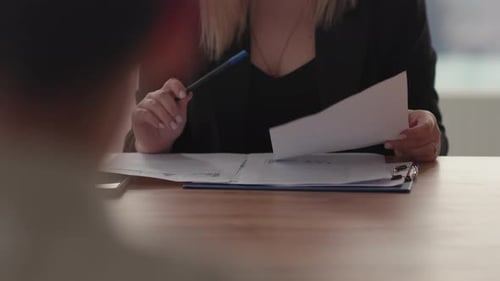 Cropped View of a Woman Studying a Folder with Documents Businesswoman Shows Company Financial