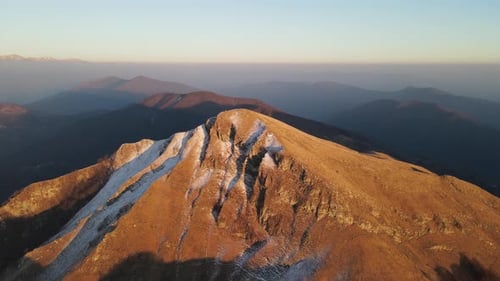 Aerial view of golden mountain peak, Italy.