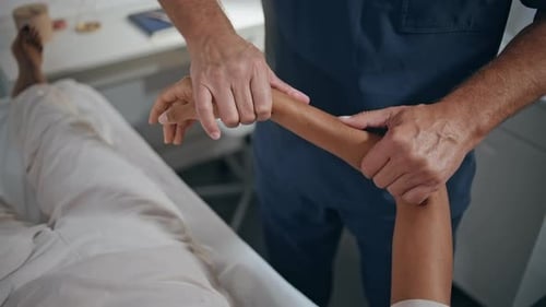 Physiotherapist Examine Woman Arm in Clinic Closeup Man Examine Trauma Recovery