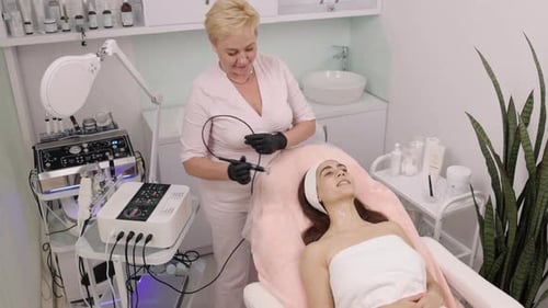 Aesthetician Performs Facial Treatment on Young Adult