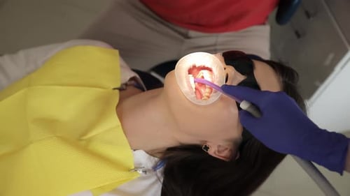 Dentist Working on Woman's Teeth Close Up