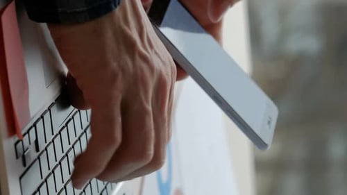 Man Using Laptop and Mobile Phone Close Up