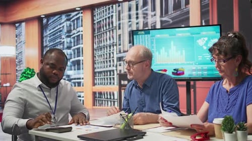 Professionals Reviewing Charts and Data in Modern Office