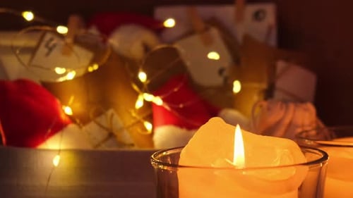 Burning Candles with Christmas Lights and Decorations