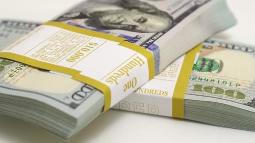 Stack of Bank Bundles with US Dollars on a White Background Closeup Shot of New Freshly Printed