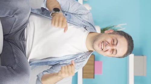 Vertical video of The man is dancing in a funny way.