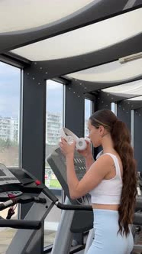 Attractive Woman Running on Treadmill in Sport Gym Sport Life and Sport Equipment Back View