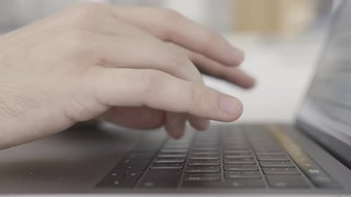 Hands Typing on a Laptop Keyboard Close Up