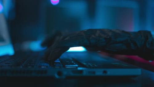 Close up hand of Women hacker With a mask executing digital espionage