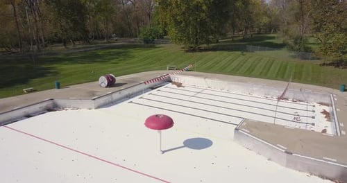 Closed empy water park with splash areas recreational water play space shut down or abandoned during