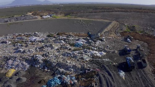 Aerial View of Massive Garbage Landfill on Sunny Day