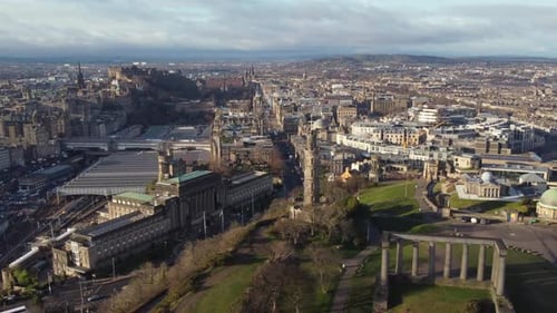 Aerial view from the top of Calton Hill in Edinburgh looking towards the city centre. Flying left to