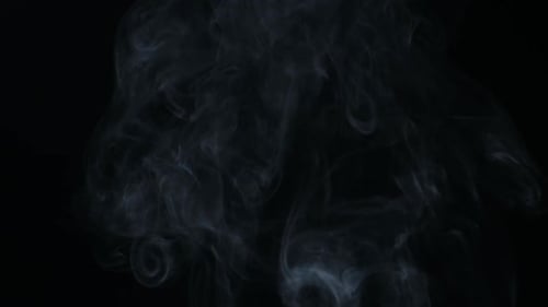Slow motion of white smoke, fog, mist, vapor on a black background.