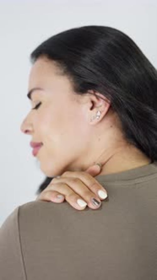Close up of hispanic woman massaging her painful neck and shoulders