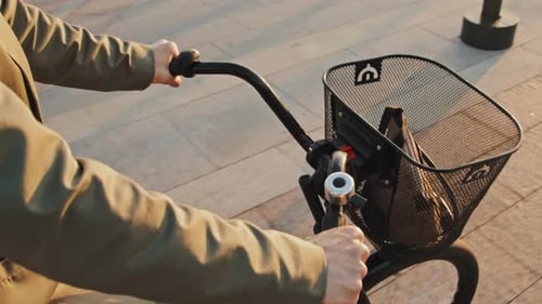 Unrecognizable Woman Riding Bicycle Early In Morning