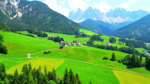 Aerial of Quaint Town of St. Magdalena with Alps Backdrop, Dolomites, Italy