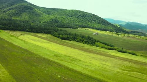 Aerial video view from drone on natural landscape mountain pass under blue sky and clouds. Rural co