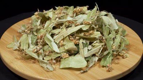 Dried Linden Flowers and Leaves on Wood Plate