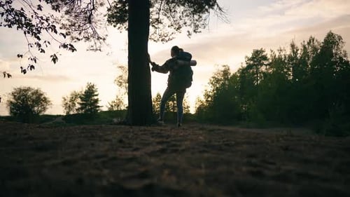 Traveler Woman with Backpack Walking on Path in forestBrave Woman Travels aloneBack View of Young