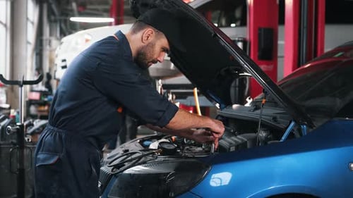 Transport is being repaired. Mechanic working in a car service station.