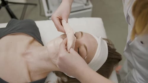 Woman Receiving Facial Mask in Salon